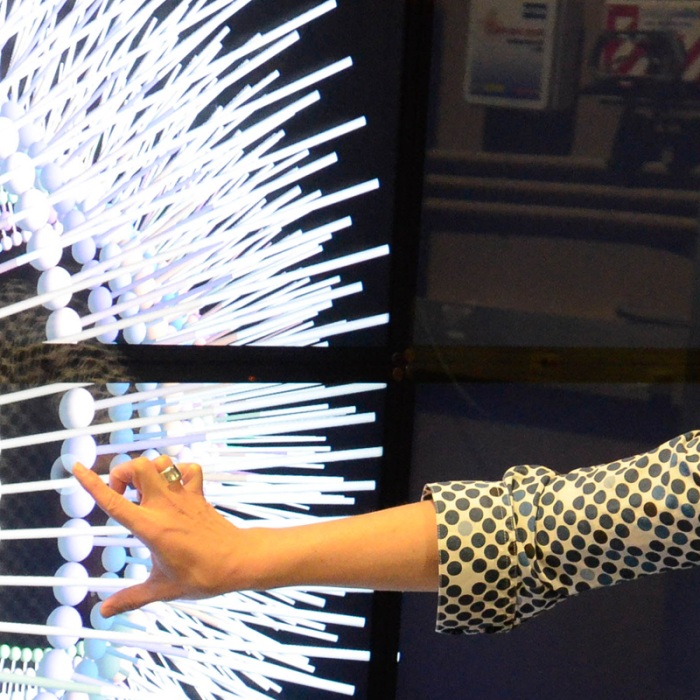 A woman in front of a digital, interactive screen at the Texas Advanced Computing Center.