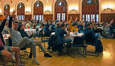 international students hold up hook em signs in the shirley bird perry ballroom