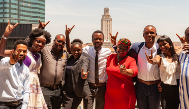 6th cohort of the Mandela Washington Fellowship pose for a photo with skyline behind them 