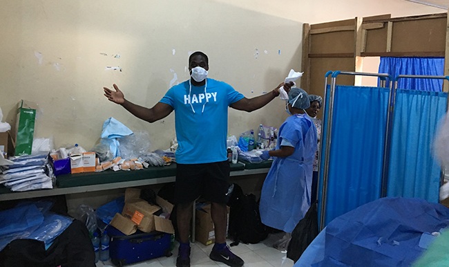 Texas Ex Sam Acho stands in a hospital in Nigeria