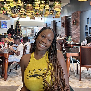 Student Usomine Omamegbe smiles in a restaurant