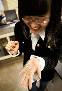 Dr. Nanshu Lu holds the tattoo piece in her hand