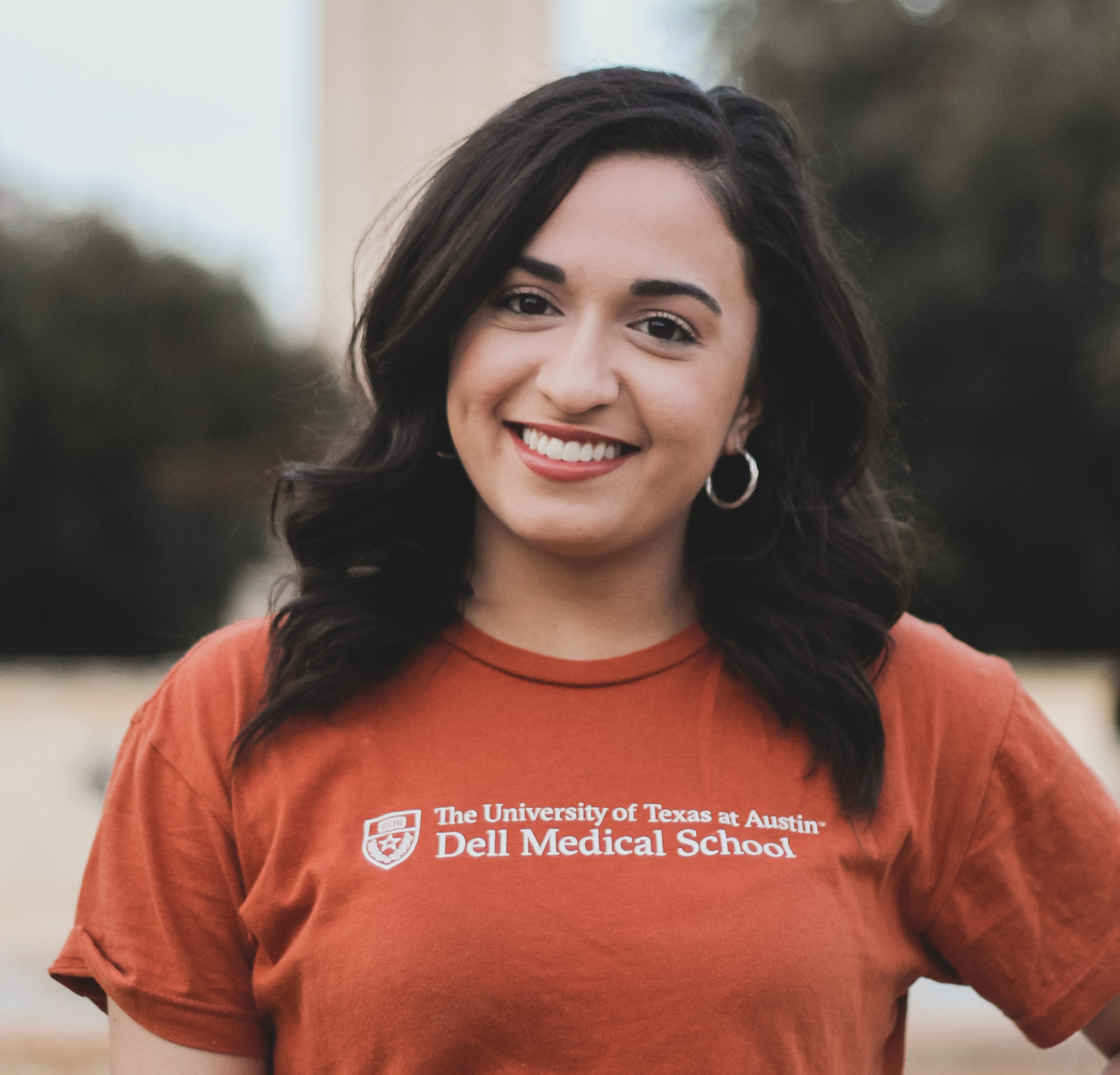 veronica poses in front of the UT tower in a burnt orange shirt 