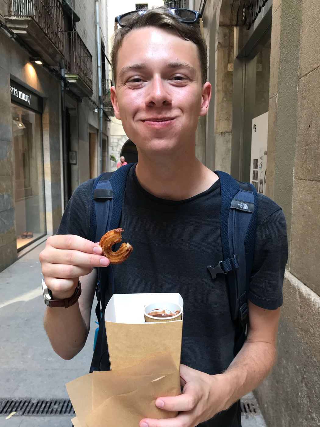 Cameron eating a snack in Barcelona