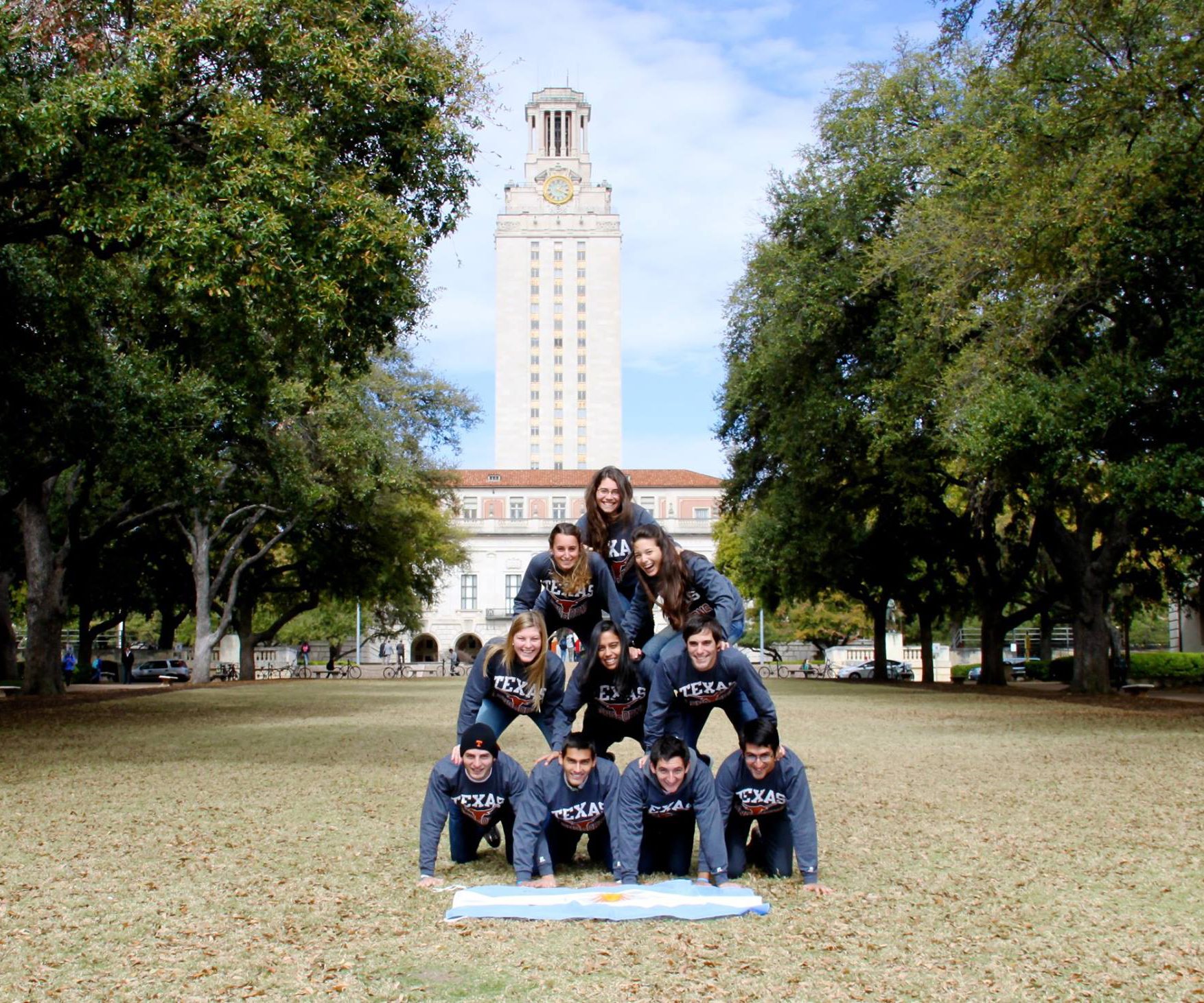 Gabriel Carlosena and his friends from the English Language Center program building a human pyramid in front of the UT Tower