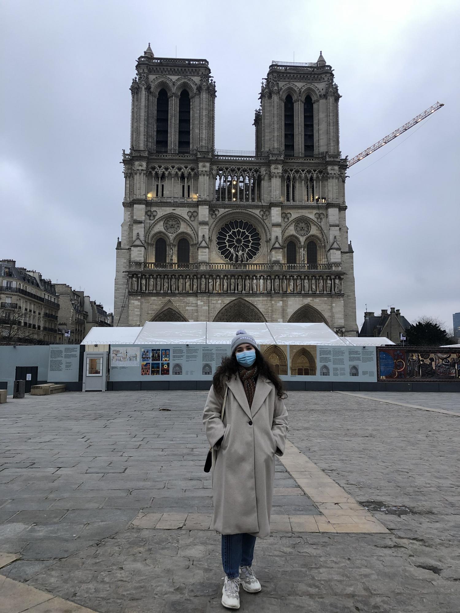Van Dijke stands in front of the Notre Dame on a chilly day.