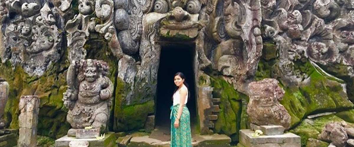 Alondra Ortiz, wearing a sarong in front of an ancient temple.