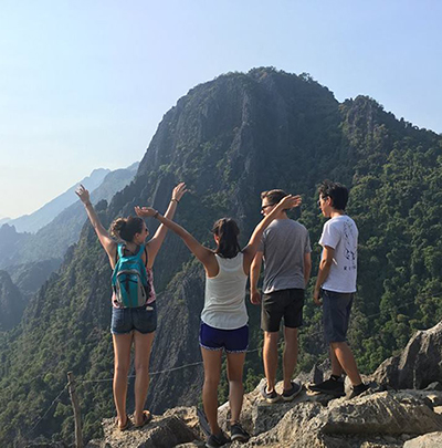 Marifer and her friends pose on a cliff in Laos.