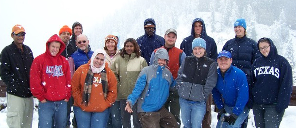 walaa stands with a large group in a snowy area 