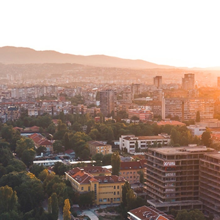 Bulgarian city divided by road with buildings and trees