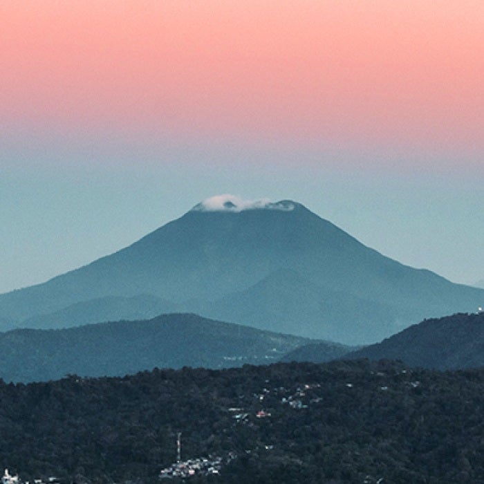 El Salvador mountain in distance under pink sky
