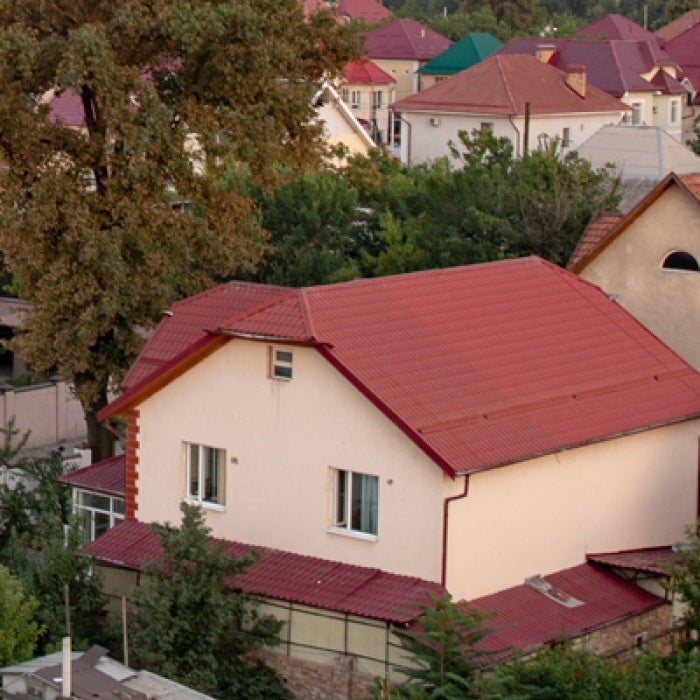 Houses with red brick roofs in town in Kyrgyzstan