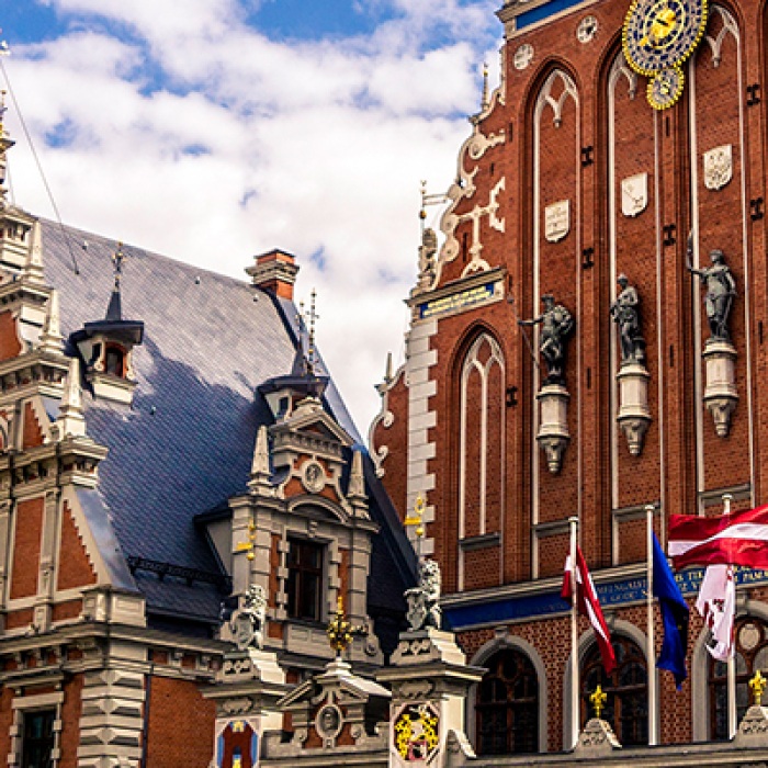 Latvia tall traditional buildings with national flag