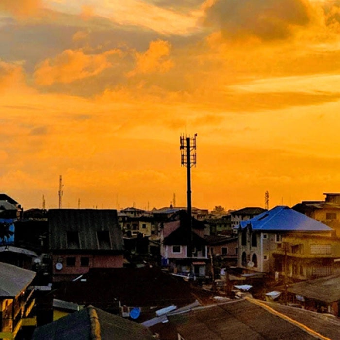 Nigerian city with sun shining in orange sky