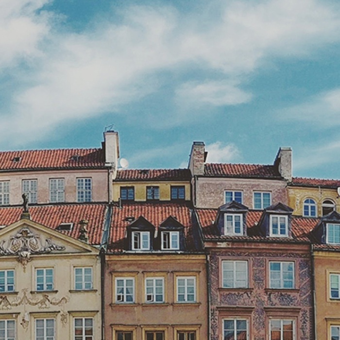 Row of Polish houses side by side against blue sky