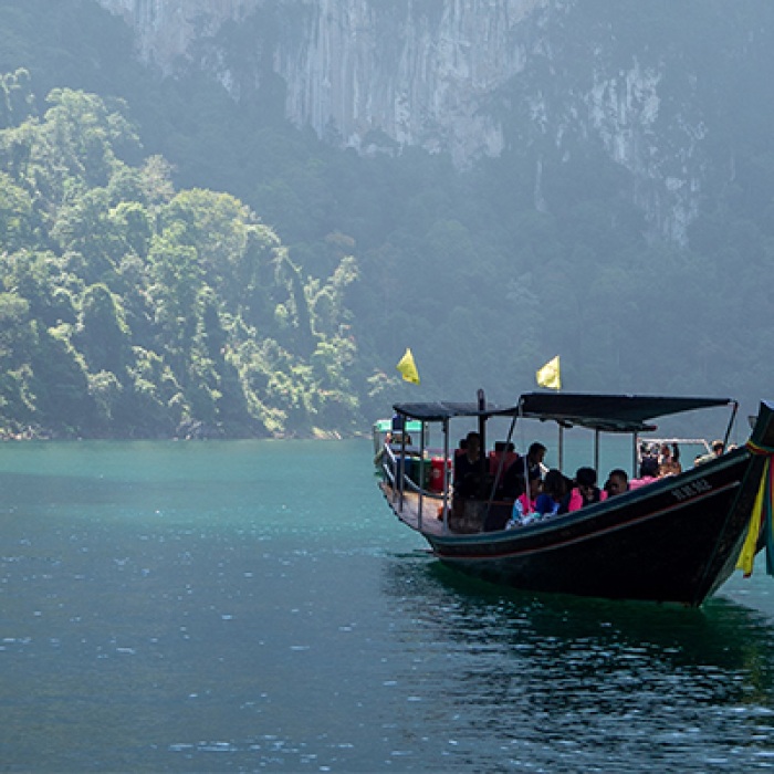 People on boat in Thailand with natural background