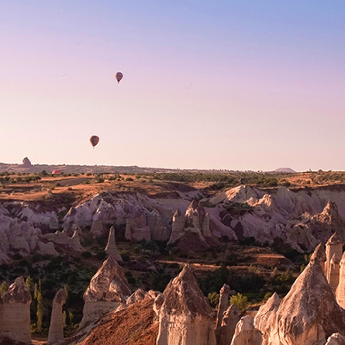 Turkey rocky landscape with hot air balloons flying in sky