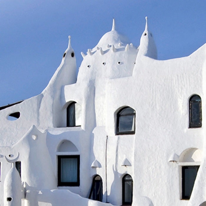 White casapueblo building with windows in Uruguay