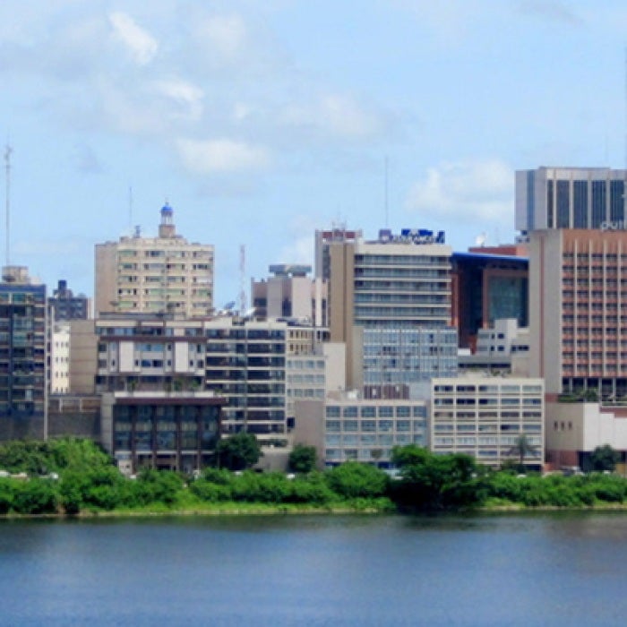 Cote d'Ivoire river with city buildings in background
