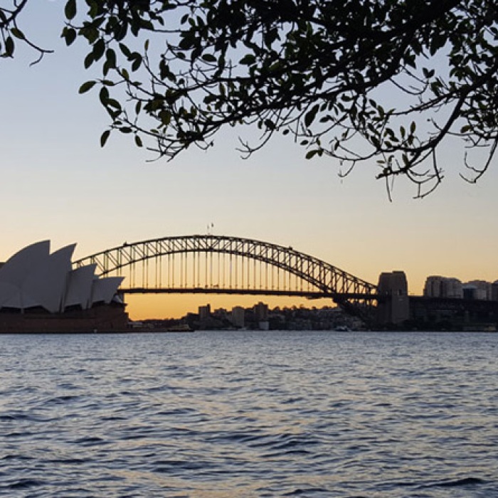 Waterfront view against the sunrise, Sydney Opera House in the background.
