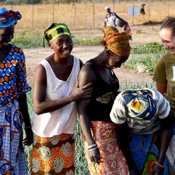 Group of women pose in field