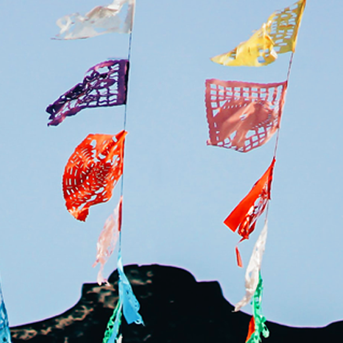 colorful flags hanging in the sky in latin america