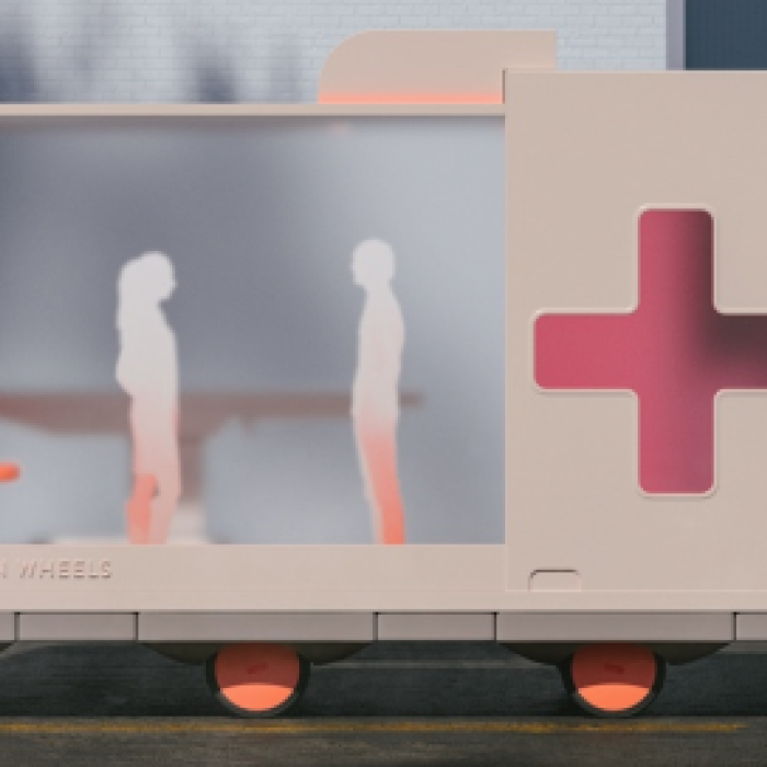 model of ambulance with cutout and two paper people silhouettes positioned inside