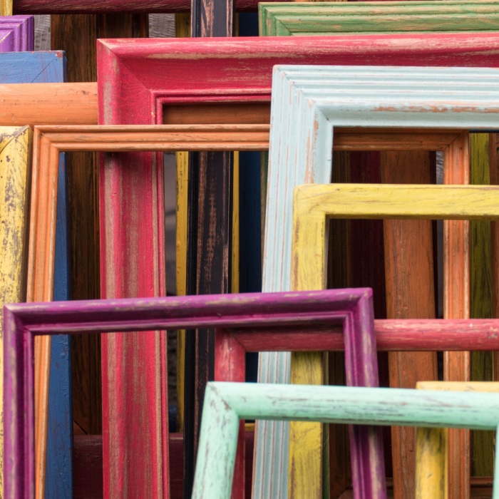 empty colorful painted wooden frames stacked on each other during daytime
