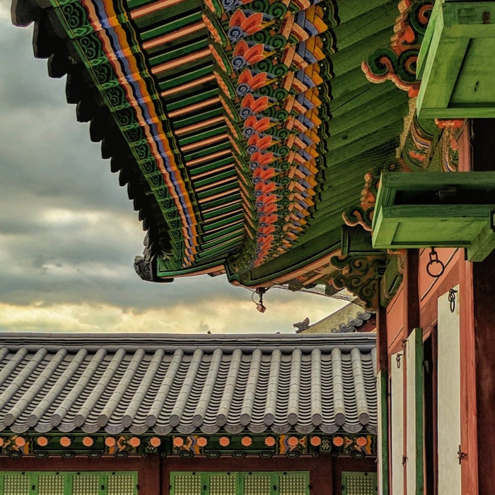 brown and green pagoda during daytime with cloudy sky