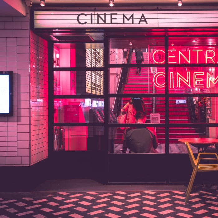 Image of a cafe with the word "Cinema" and a pink light