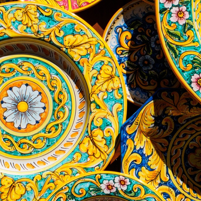 decorative yellow and blue patterned plates stacked atop one another