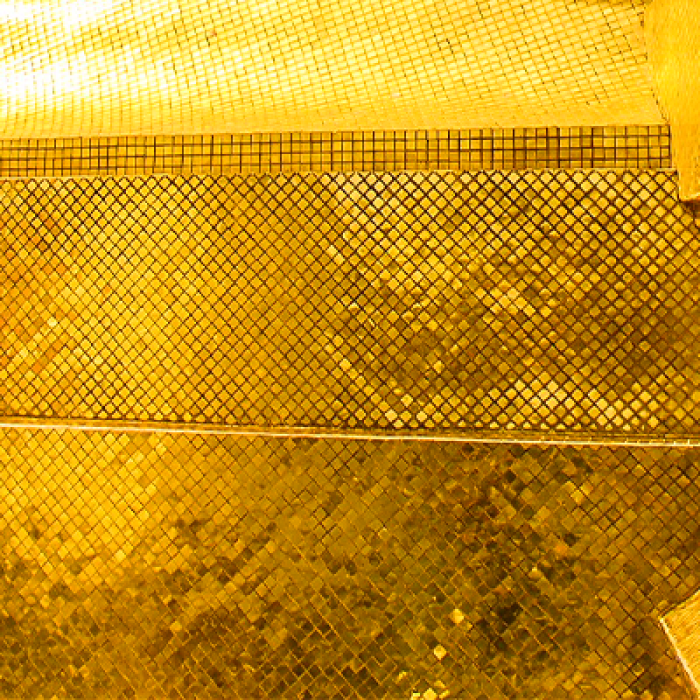 A student looks up at a gold structure. 