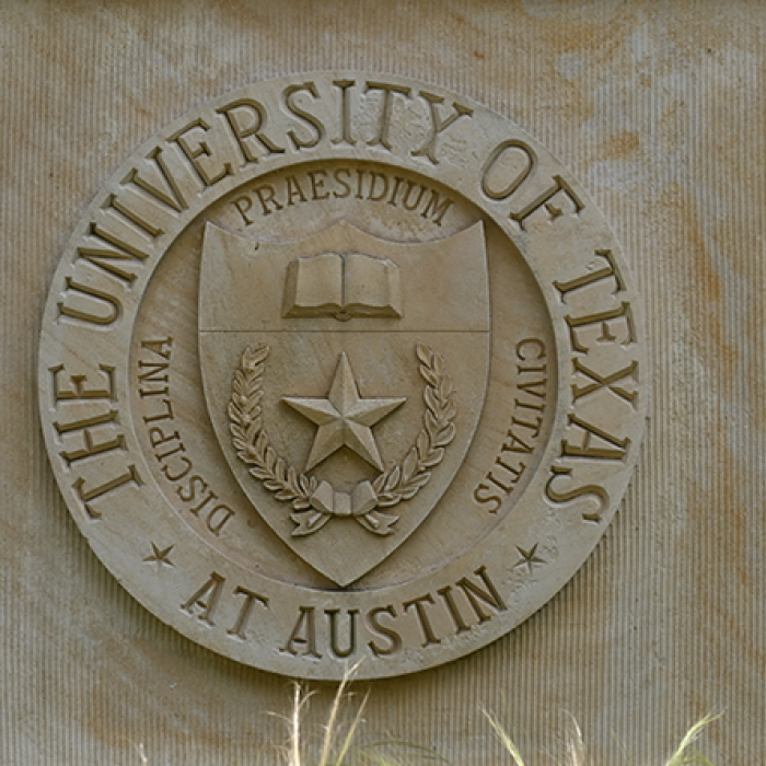Up close image of UT architecture featuring the University's seal. 