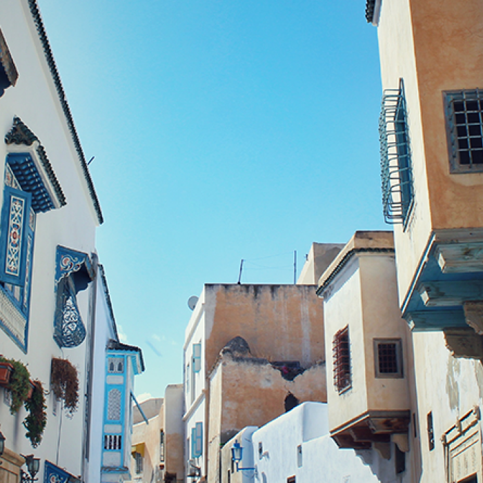 An alleyway on a sunny day in Al-Qayrawan, Tunisia.