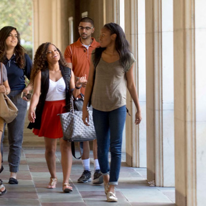 group of students walking though a courtyard on the UT Austin Campus