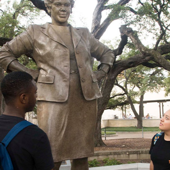 Students looking at statue of Barbara Jordan on UT campus