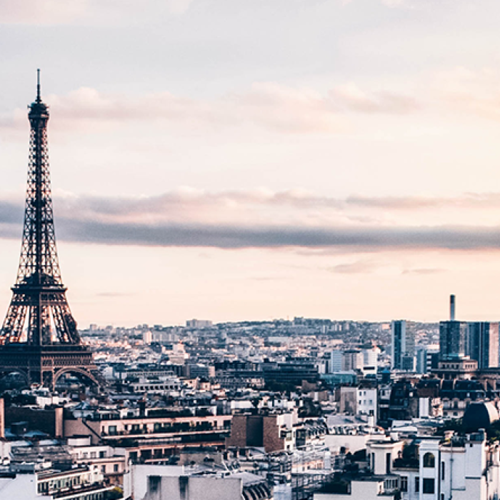 City skyline of Paris, France featuring the Eiffel tower at dawn