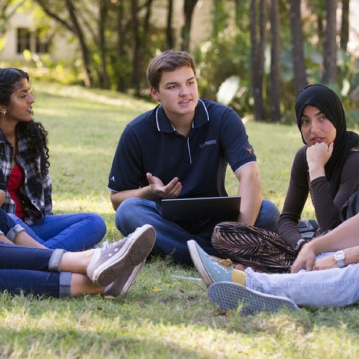 Students sitting and talking on the grass