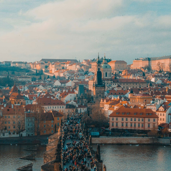 A soft and hazy beautiful Prague, as viewed from looking down the bridge across the river at the city from a higher vantage point