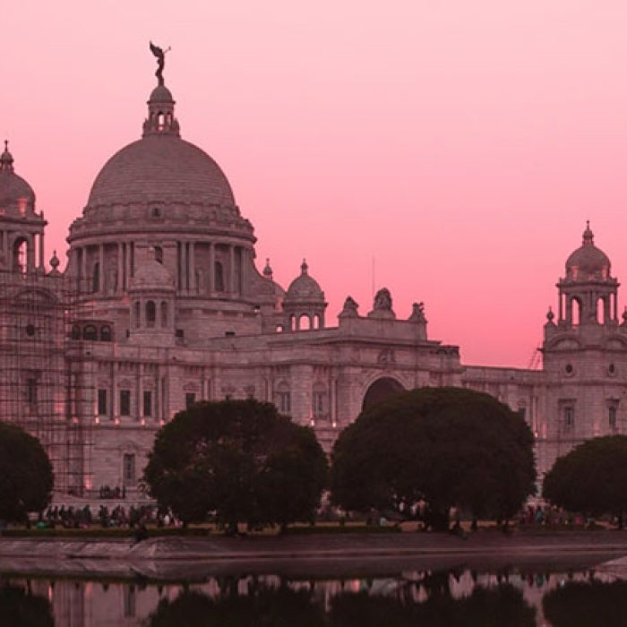 Victoria Memorial building in Central Kolkata, India at sunset with pink sky