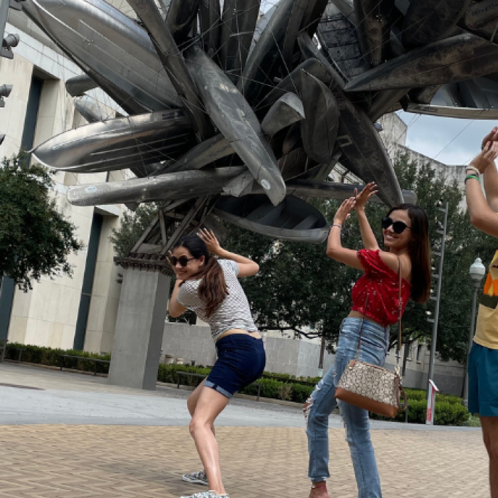 students posing with an outdoor sculpture