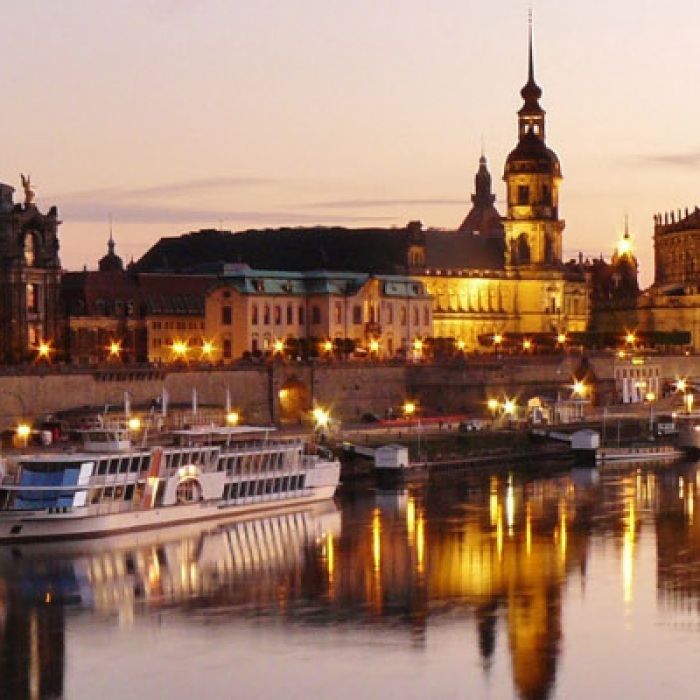 Boats on a still river with a beautiful sunset backdrop in Dresden, Germany
