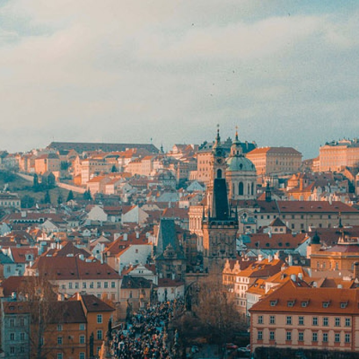 A soft and hazy beautiful Prague, as viewed from looking down the bridge across the river at the city from a higher vantage point