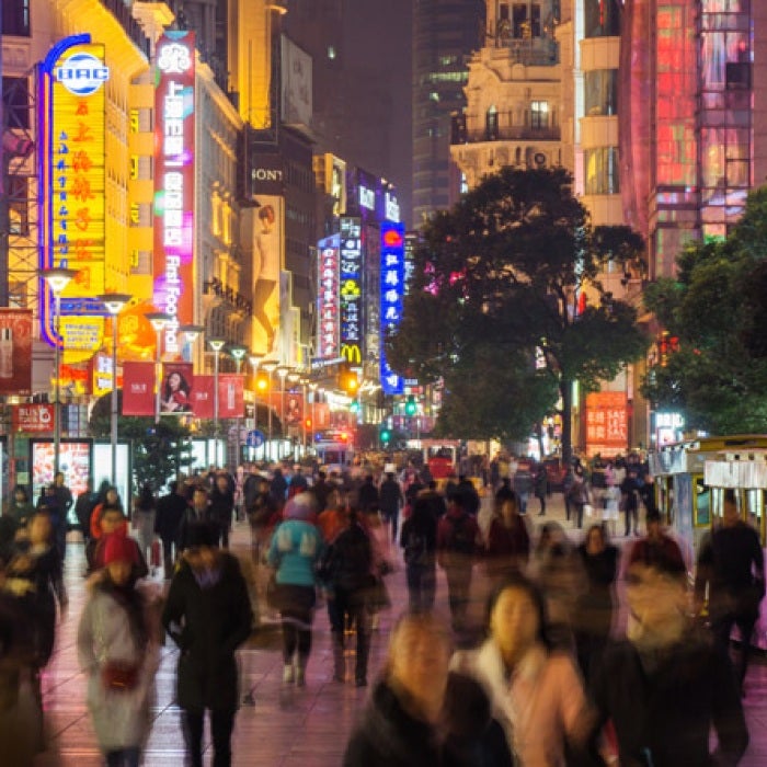 Downtown in a Chinese City with neon lights and fast moving people