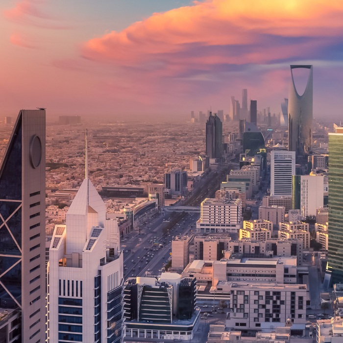 Riyadh skyline aerial shown against a gorgeous pink, blue, and purple sunset backdrop with the Tower Kingdom Center in view, Kingdom of Saudi Arabia