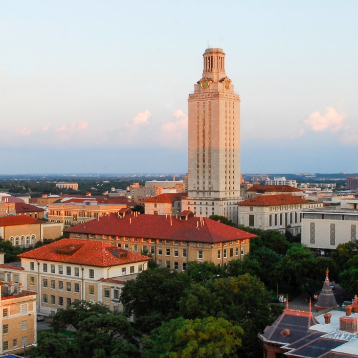 An aerial photo of the UT campus at sunset with the Tower in view