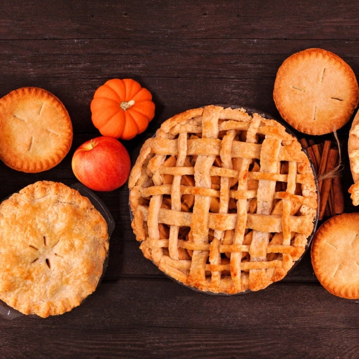 Traditional Thanksgiving pies displayed on a table with fall decor