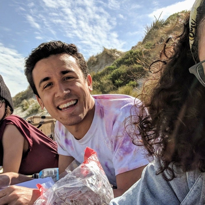 Students working together and smiling for a photo in New Zealand