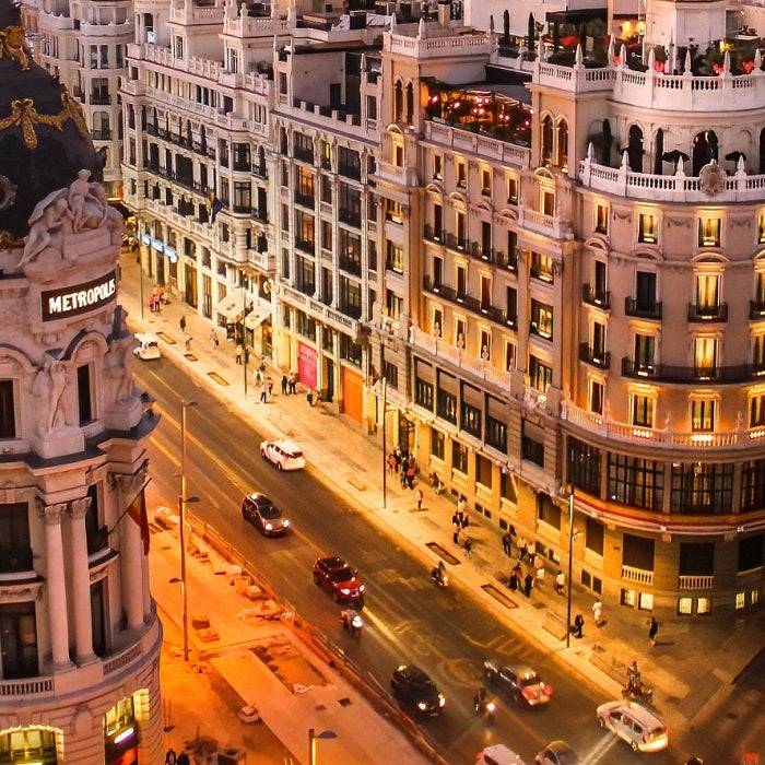 The famous street of Gran Via, surrounded by incredible architecture, are illuminated at night in Madrid, Spain.