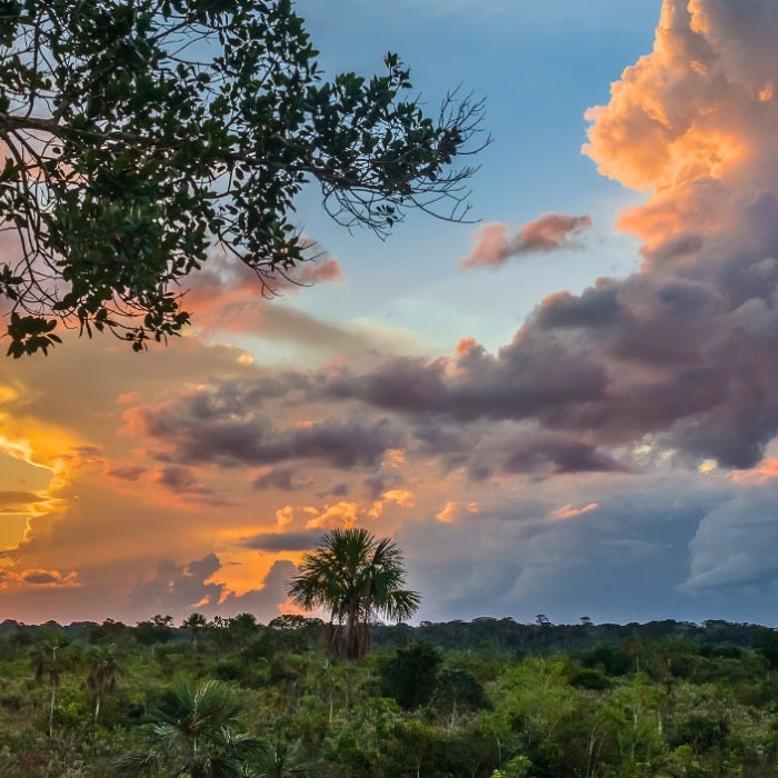 Dramatic sunlit clouds hang in the sky above Sabaluyoc, Peru
